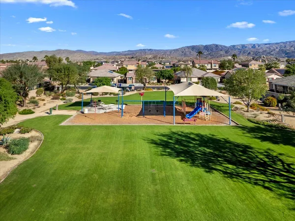 an aerial view of a house with a yard and potted plants
