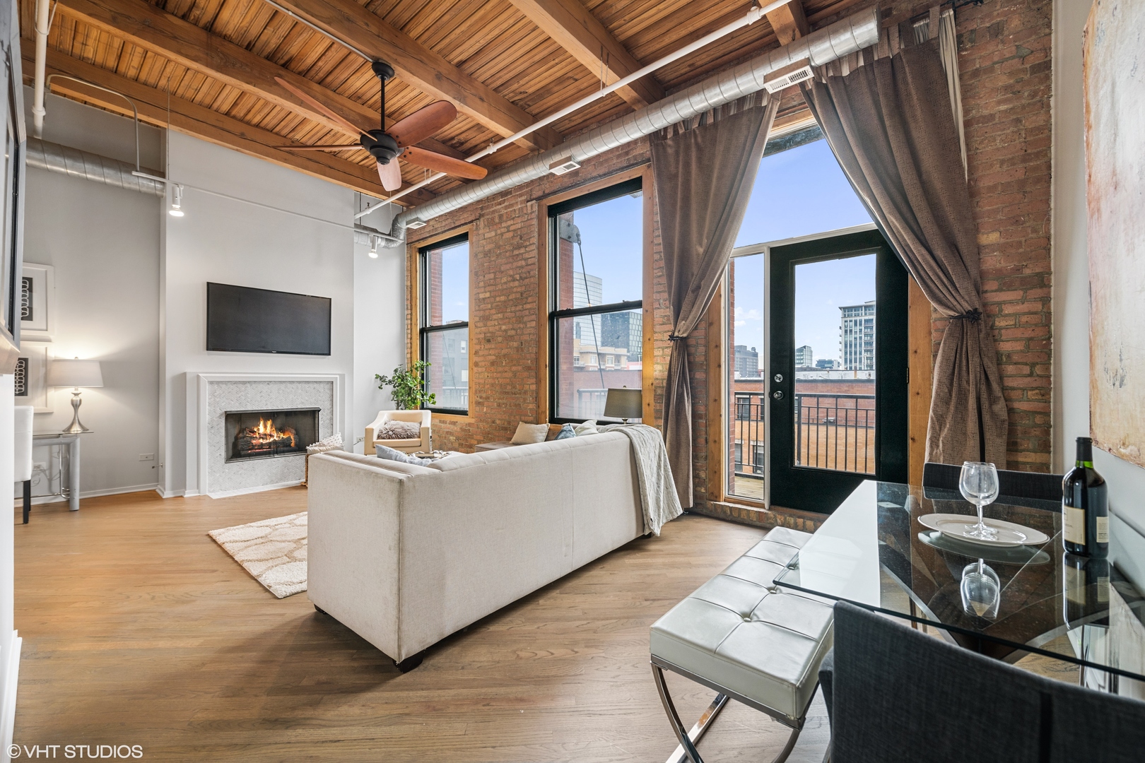 616 West Fulton Street, Unit 408 Chicago, IL 60661 - Photo 2 of 14 a living room with furniture and a fireplace