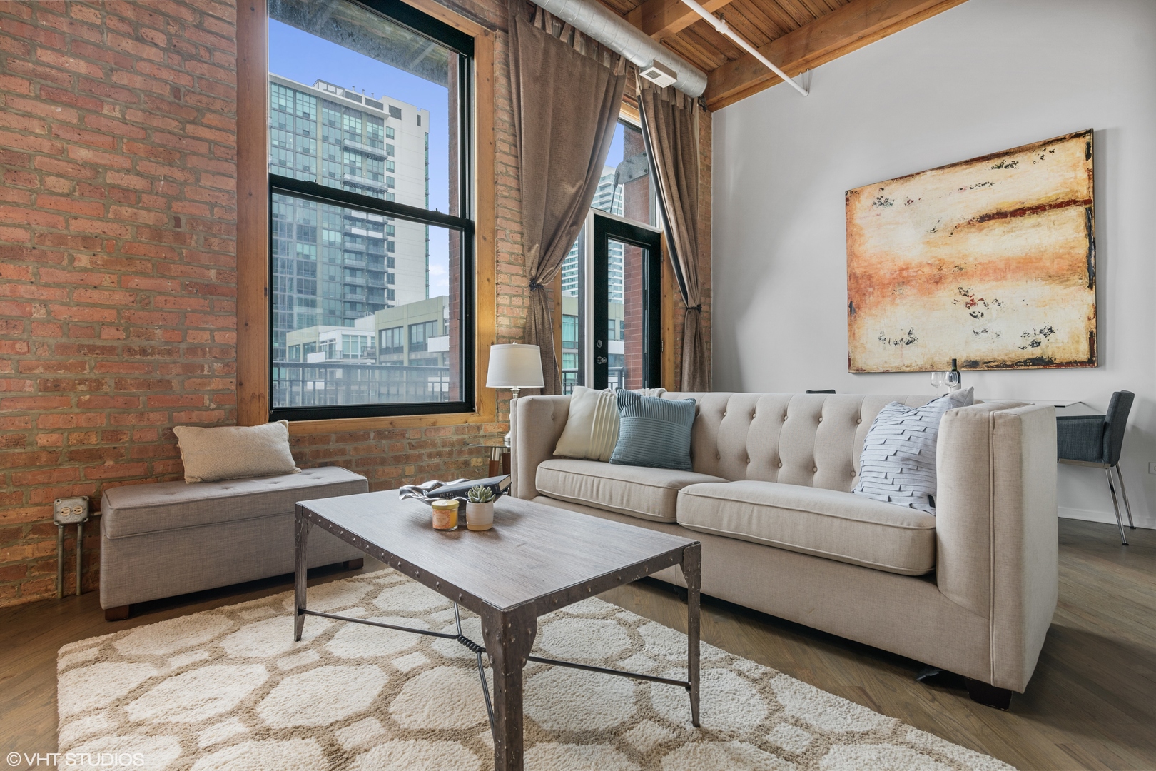 616 West Fulton Street, Unit 408 Chicago, IL 60661 - Photo 3 of 14 a living room with furniture and a painting on the wall