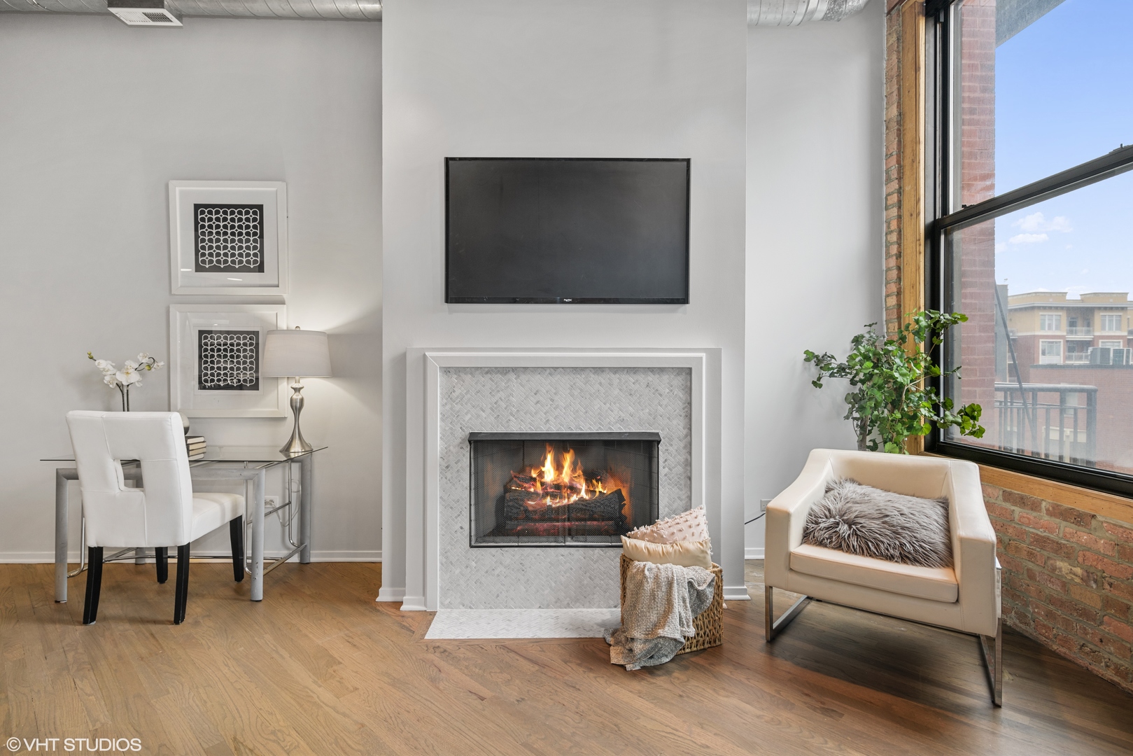 616 West Fulton Street, Unit 408 Chicago, IL 60661 - Photo 6 of 14 a living room with furniture a flat screen tv and a fireplace