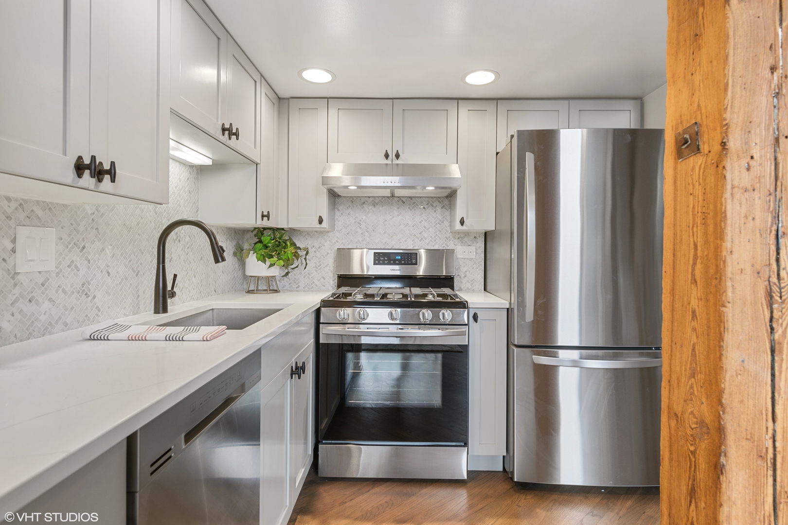 616 West Fulton Street, Unit 408 Chicago, IL 60661 - Photo 8 of 14 a kitchen with stainless steel appliances granite countertop a sink stove and refrigerator