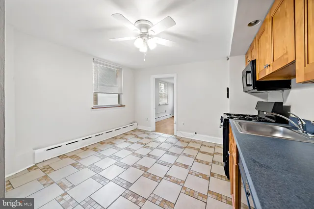 a view of a kitchen with a sink a window and cabinets