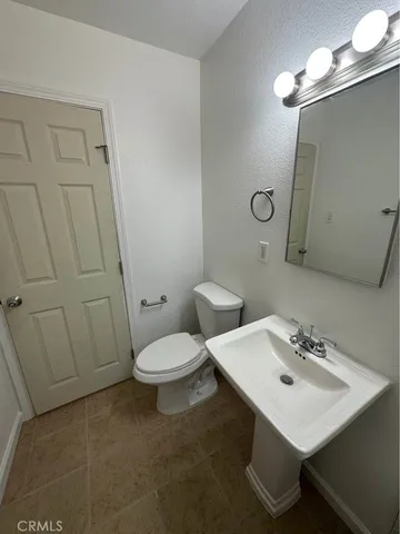 a bathroom with a sink a toilet and mirror