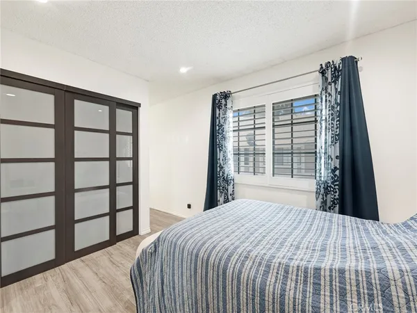 a bedroom with a bed and a large window
