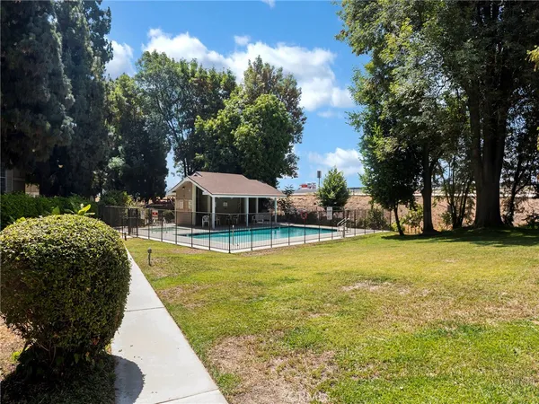 a view of a house with swimming pool and sitting area
