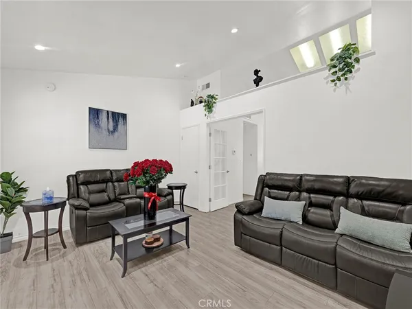 a living room with furniture and a chandelier