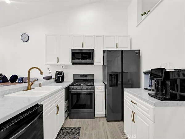 a kitchen with a refrigerator stove and sink