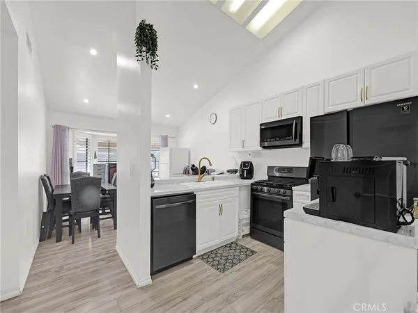 a kitchen with a sink stainless steel appliances and cabinets