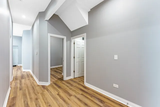 a view of a room with wooden floor and entryway