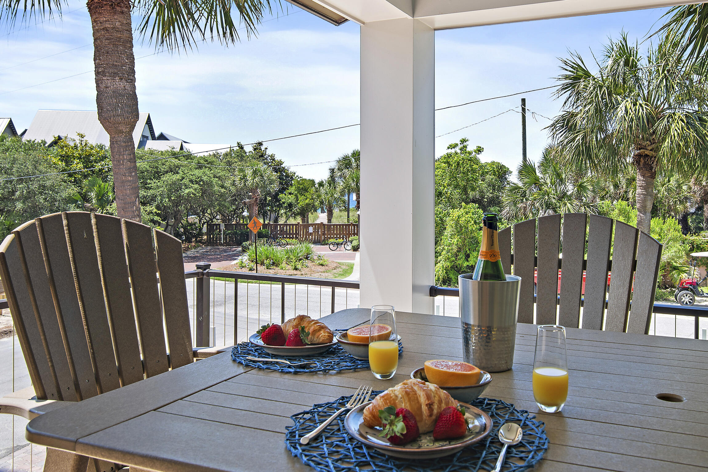 255 Blue Mountain Road, Unit 8 Santa Rosa Beach, FL 32459 - Photo 36 of 53 a view of a patio with table and chairs potted plants with wooden fence