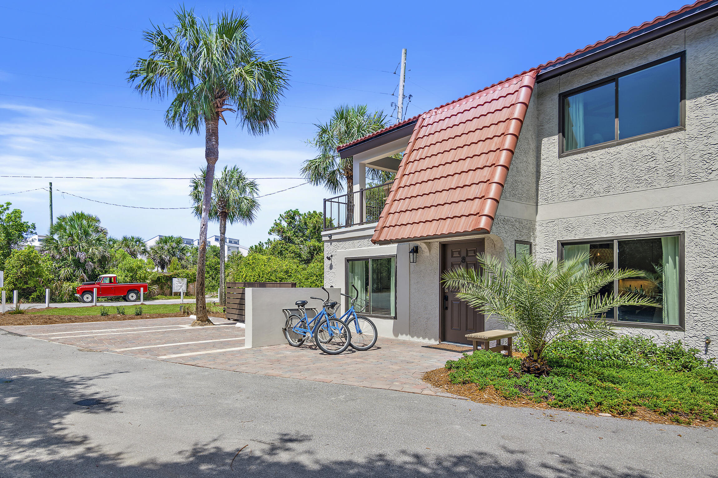 255 Blue Mountain Road, Unit 8 Santa Rosa Beach, FL 32459 - Photo 43 of 53 a front view of a house with a garden and a garage