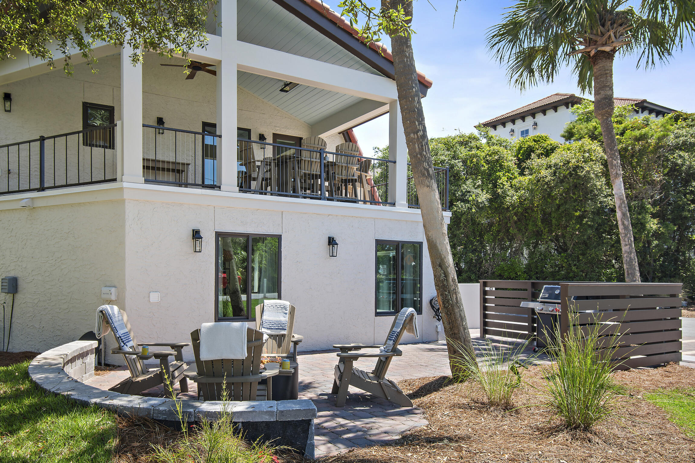 255 Blue Mountain Road, Unit 8 Santa Rosa Beach, FL 32459 - Photo 46 of 53 a view of a patio with table and chairs potted plants with wooden floor