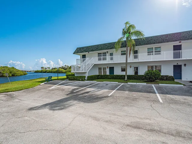 a living room with furniture a ceiling fan and a rug