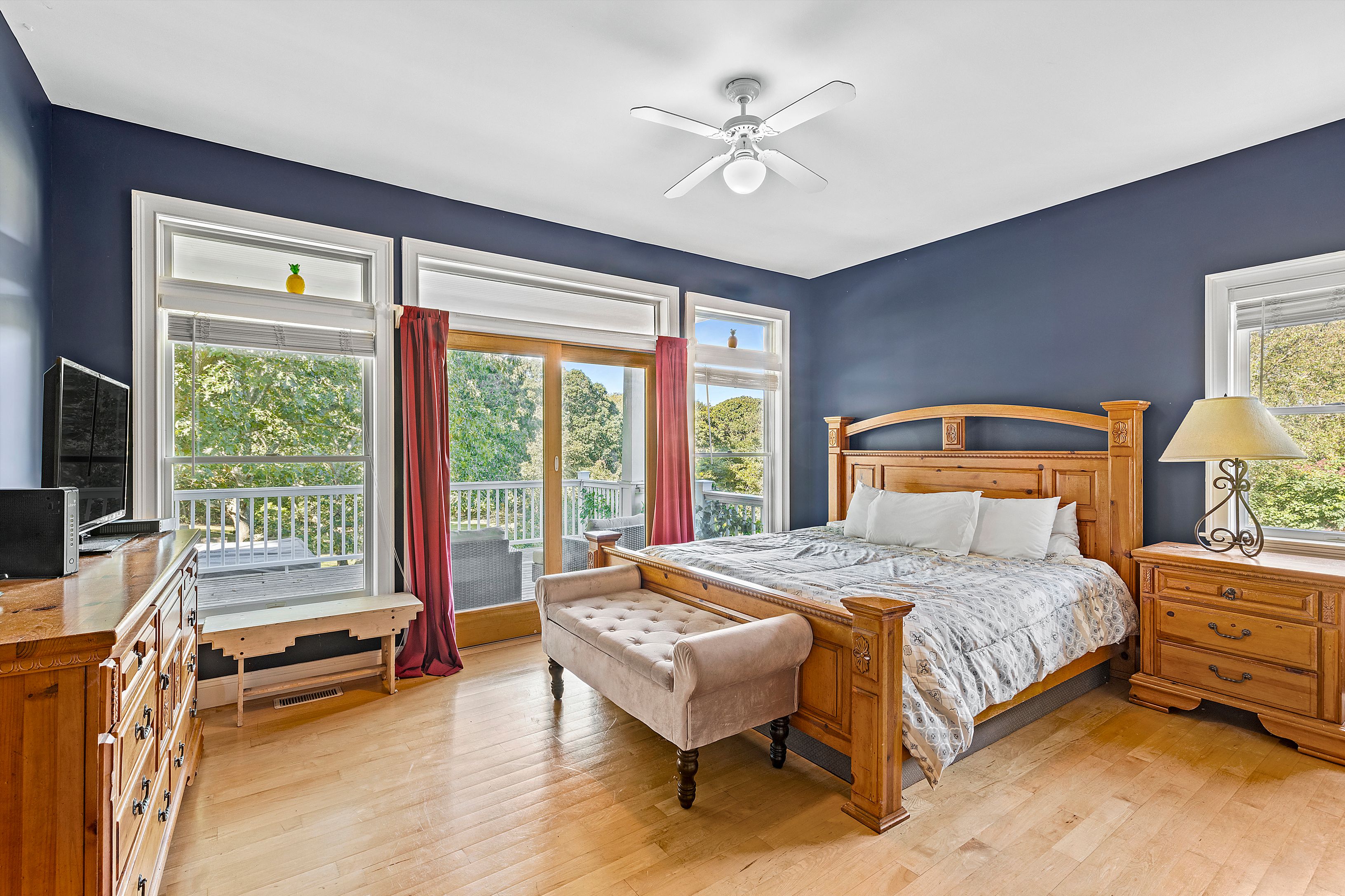 4 Bayberry Road Montauk, NY 11954 - Photo 15 of 29 a bedroom with a bed and a couch next to a window