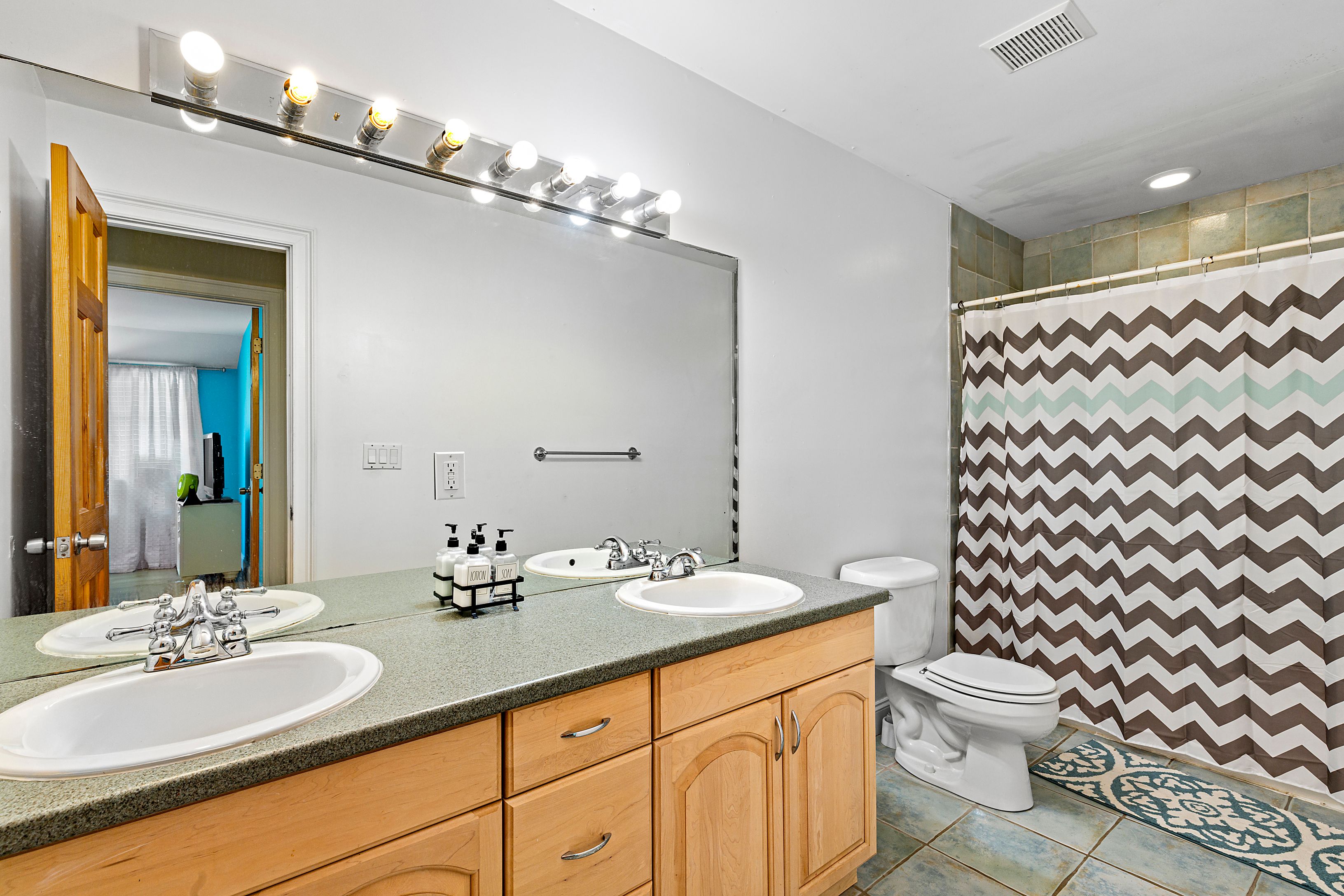 4 Bayberry Road Montauk, NY 11954 - Photo 19 of 29 a bathroom with a double vanity sink mirror and toilet