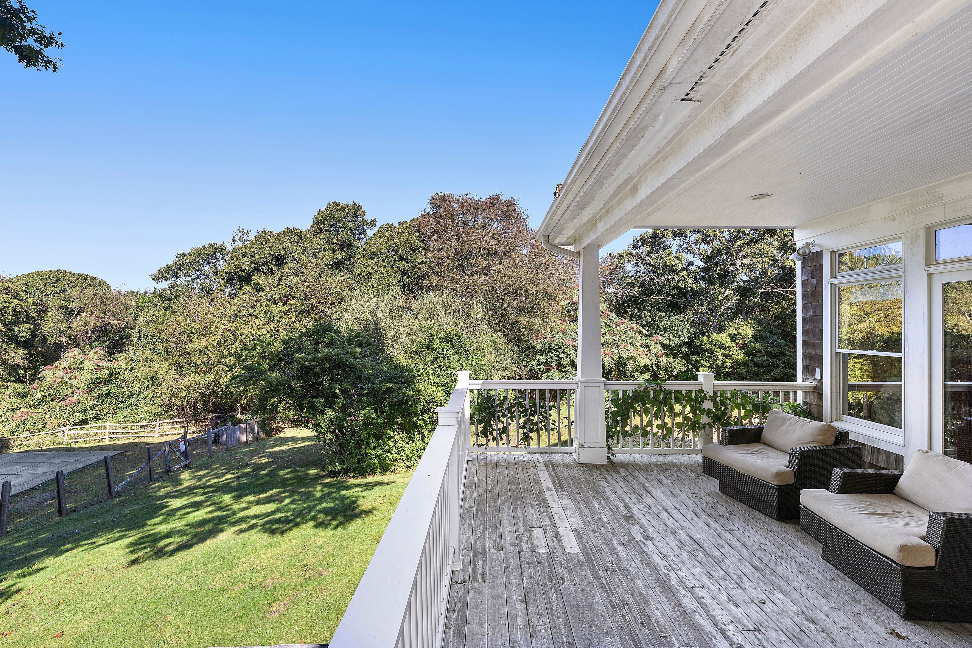 4 Bayberry Road Montauk, NY 11954 - Photo 23 of 29 a balcony with wooden floor table and chairs