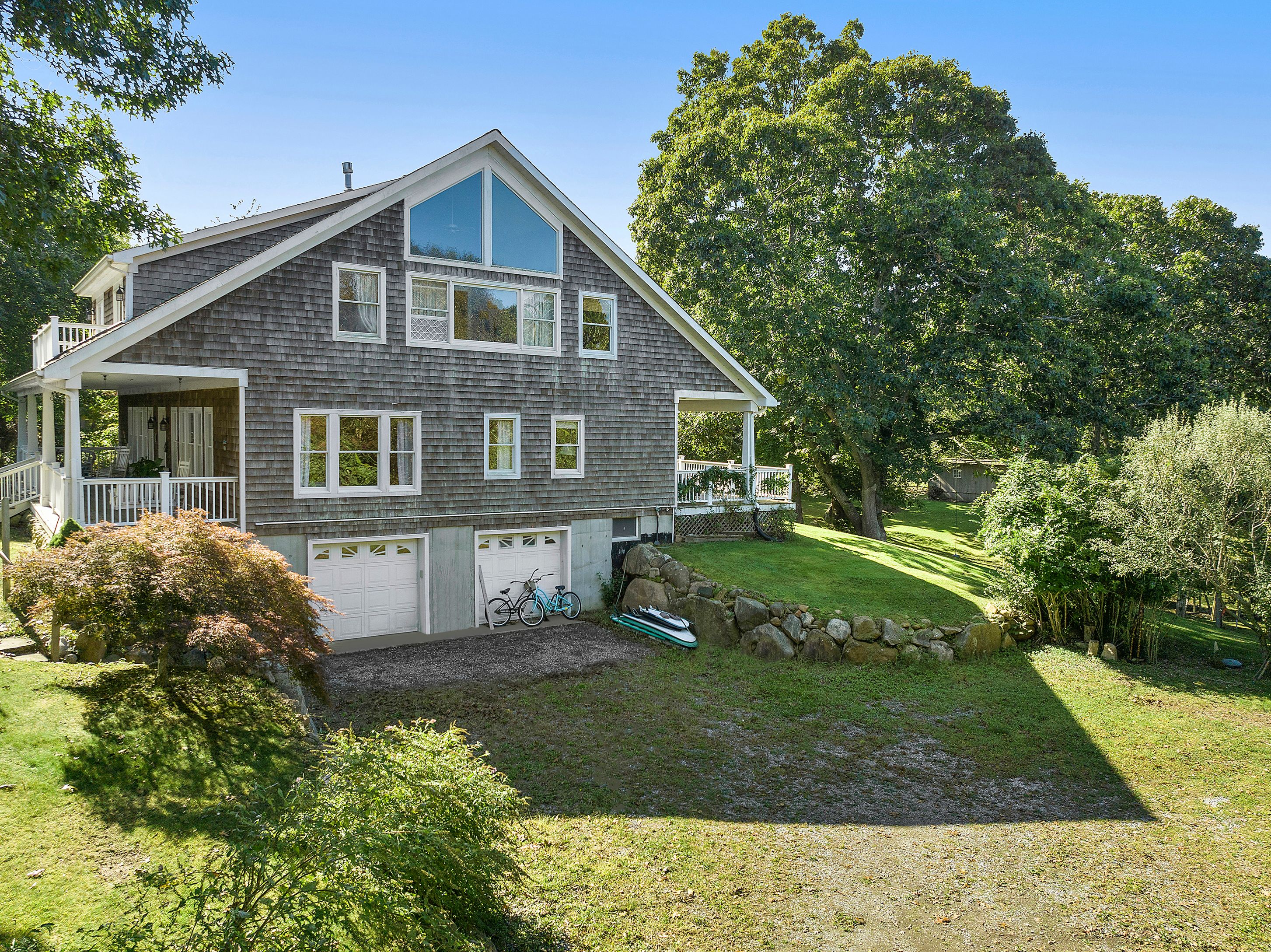4 Bayberry Road Montauk, NY 11954 - Photo 24 of 29 a front view of a house with a yard