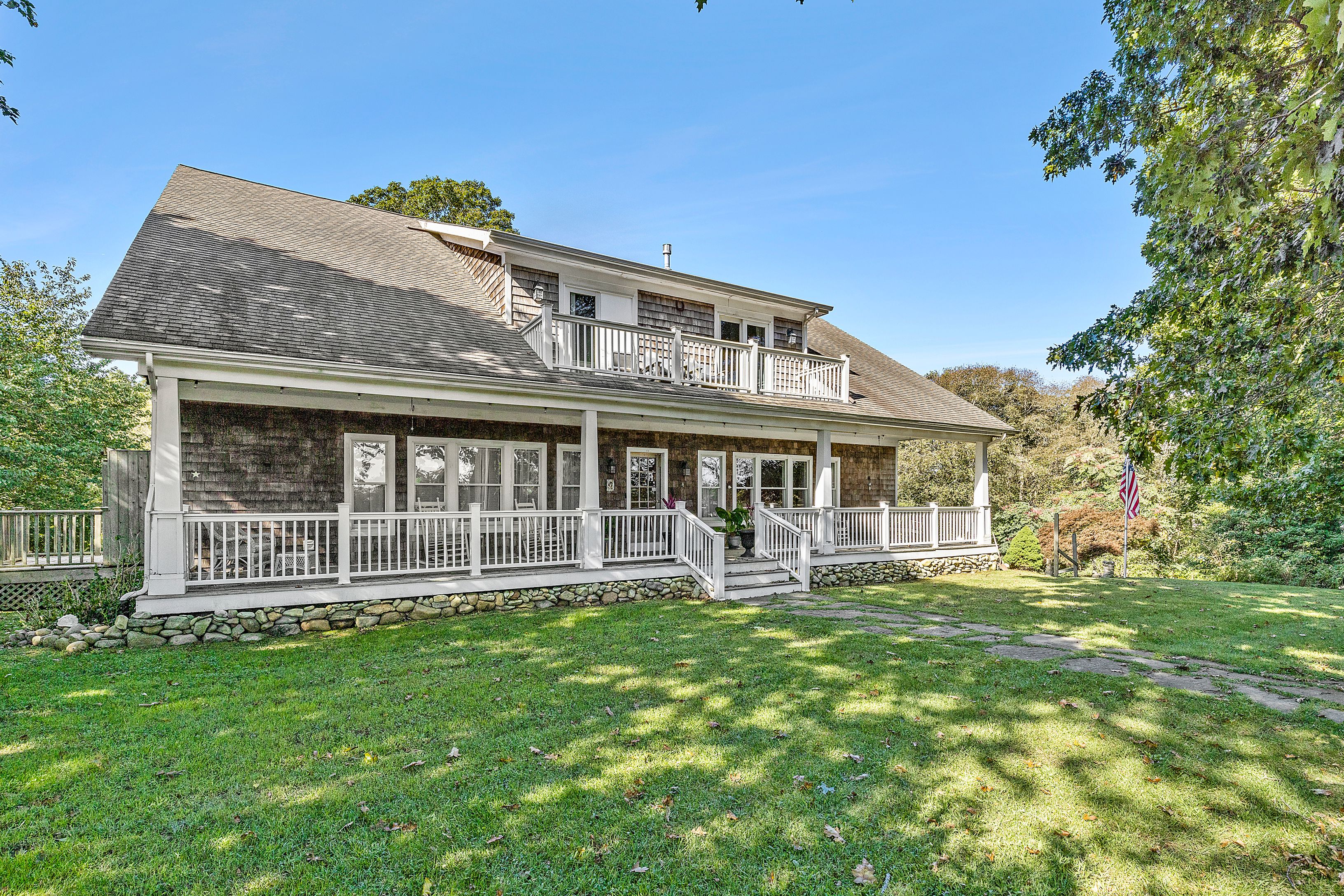 4 Bayberry Road Montauk, NY 11954 - Photo 3 of 29 a front view of a house with a garden