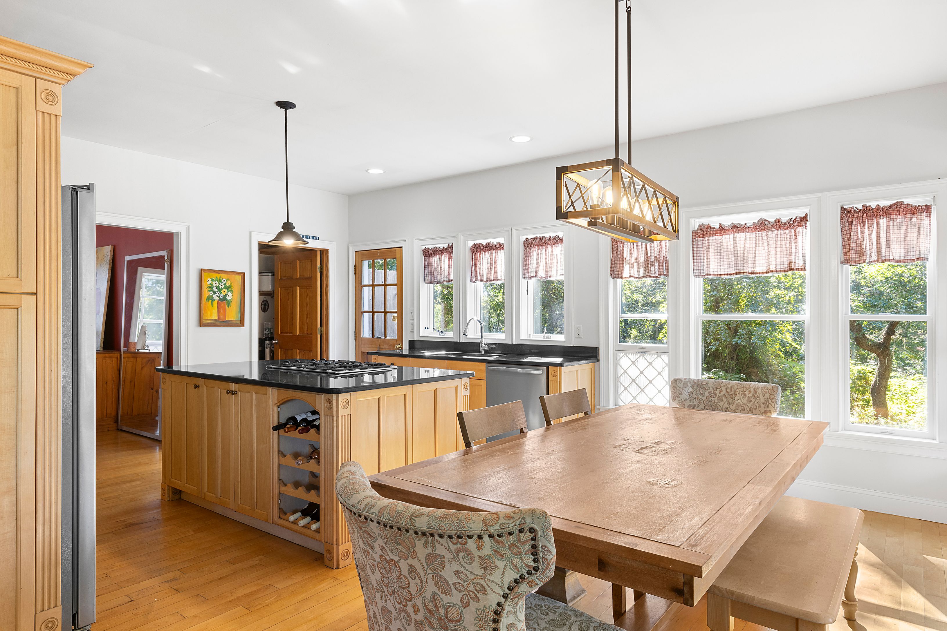 4 Bayberry Road Montauk, NY 11954 - Photo 6 of 29 a dining table chairs and a chandelier