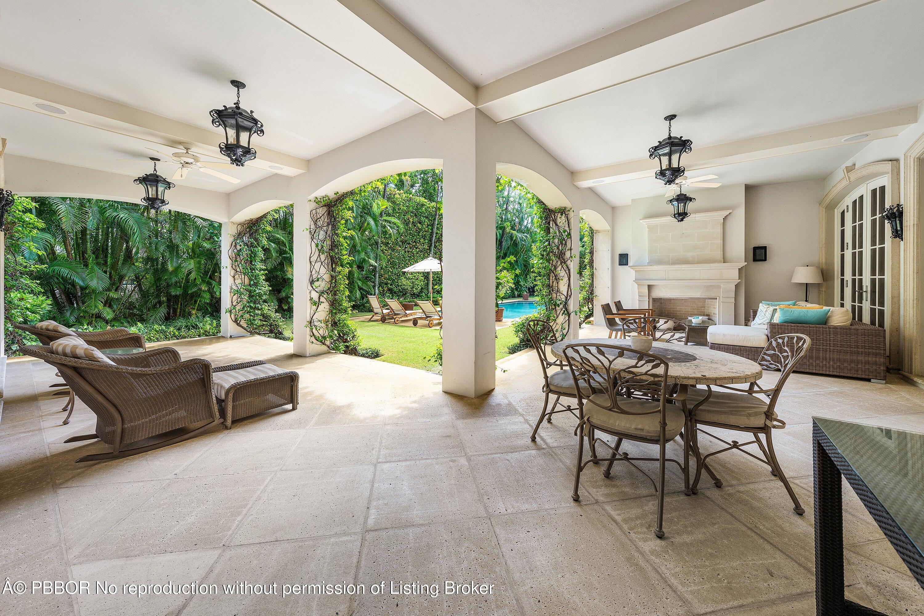 242 Wells Road Palm Beach, FL 33480 - Photo 35 of 54 a dining room with furniture a chandelier and a rug