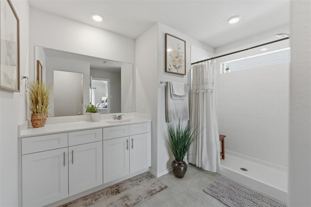 316 Sculptors Crossing Springtown, TX 76082 - Photo 15 of 19 a spacious bathroom with a shower sink and mirror