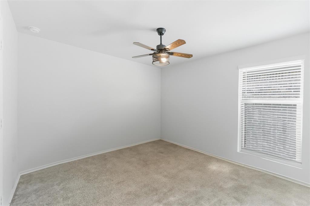316 Sculptors Crossing Springtown, TX 76082 - Photo 6 of 19 an empty room with a window and a fan