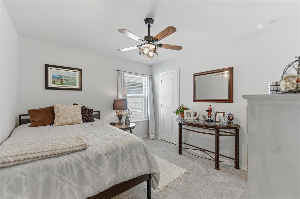 316 Sculptors Crossing Springtown, TX 76082 - Photo 7 of 19 a bedroom with a bed and a chandelier