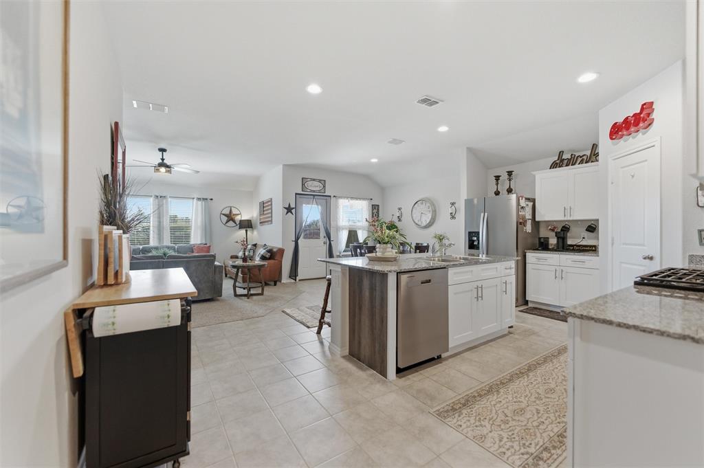 316 Sculptors Crossing Springtown, TX 76082 - Photo 8 of 19 a kitchen with cabinets and chairs