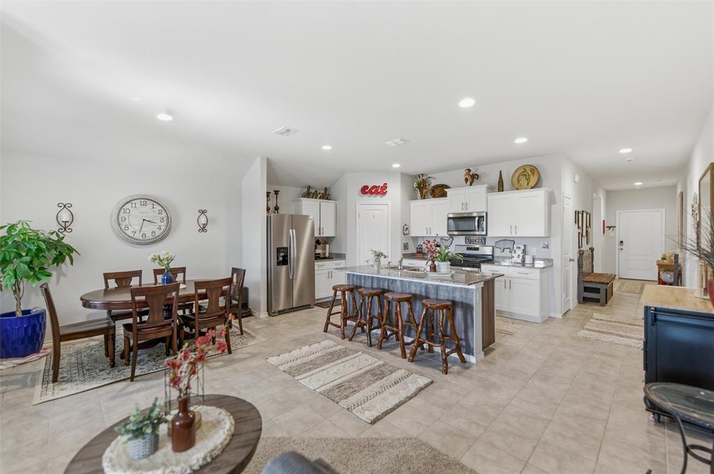 316 Sculptors Crossing Springtown, TX 76082 - Photo 10 of 19 a living room with furniture a dining table and kitchen view