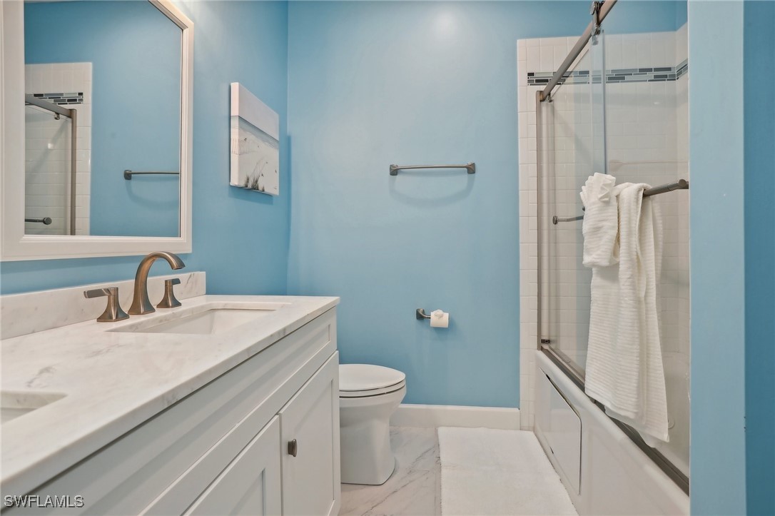 8335 Main Street Bokeelia, FL 33922 - Photo 38 of 47 a bathroom with a sink a toilet and shower