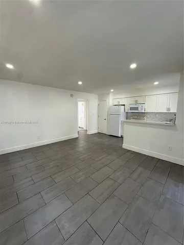a view of a kitchen with a sink and microwave