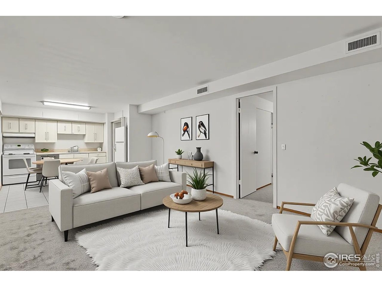 a living room with furniture and view of kitchen