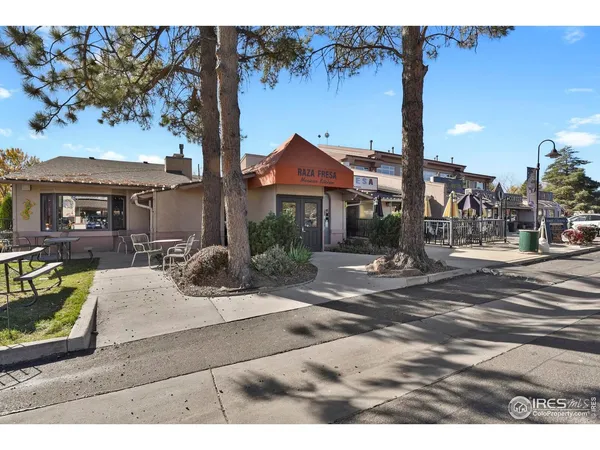 a view of a patio with a table and chairs