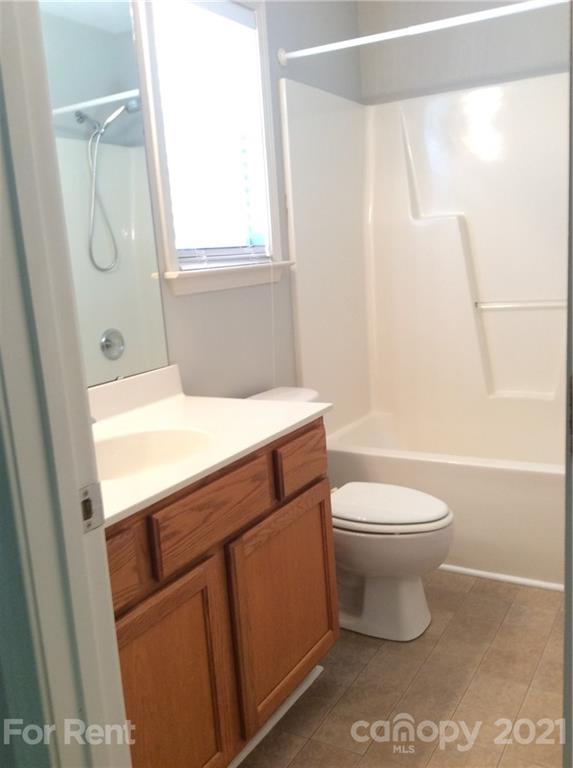 6614 Bevington Ridge Road, Unit B Charlotte, NC 28277 - Photo 13 of 16 a bathroom with a sink a toilet and shower