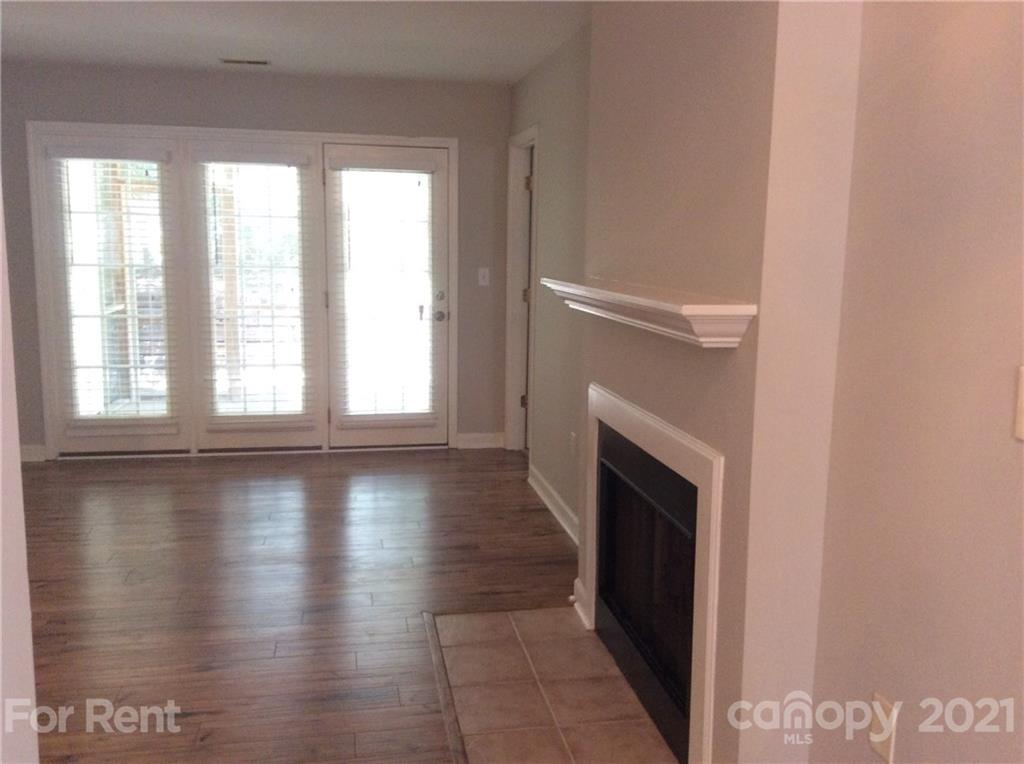 6614 Bevington Ridge Road, Unit B Charlotte, NC 28277 - Photo 4 of 16 a view of empty room with wooden floor and fireplace