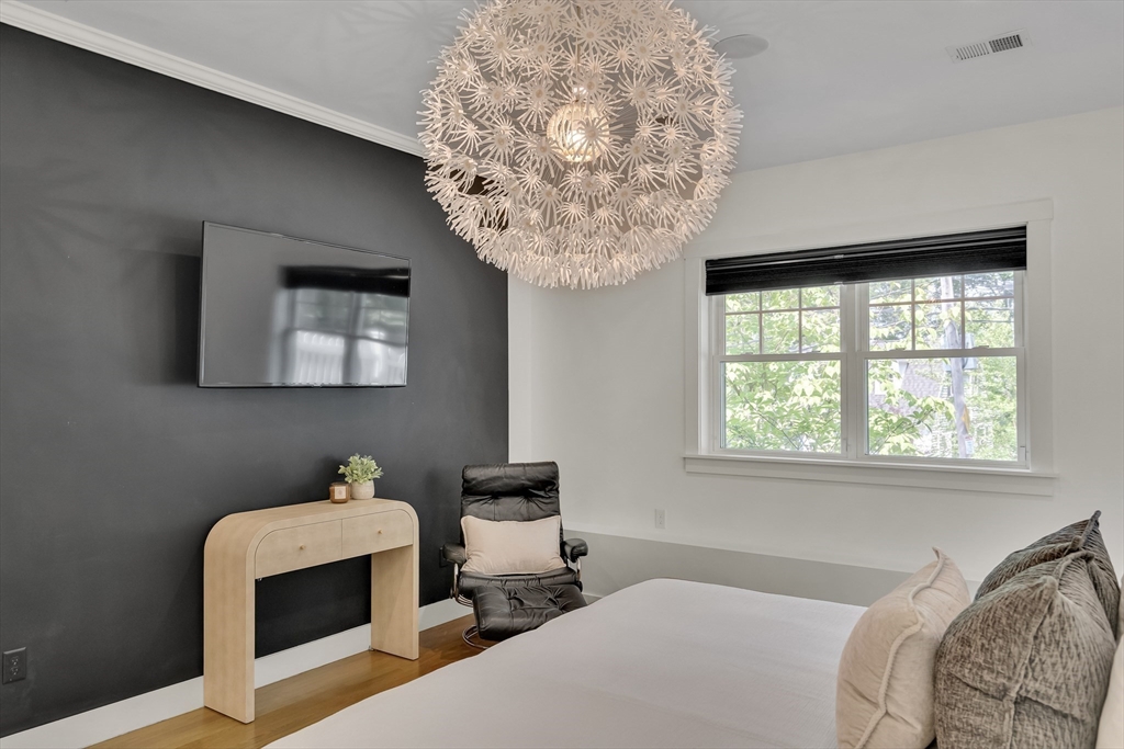 20 Lila Road Boston, MA 02130 - Photo 12 of 28 a bedroom with a bed and a chandelier