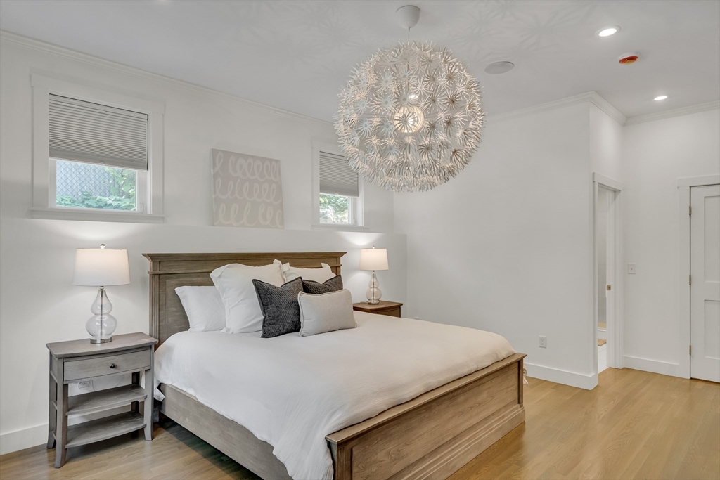 20 Lila Road Boston, MA 02130 - Photo 13 of 28 a bedroom with a bed and a chandelier