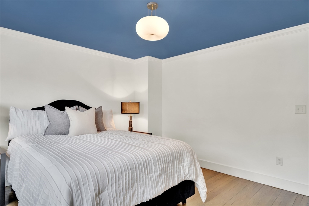 20 Lila Road Boston, MA 02130 - Photo 18 of 28 a bedroom with a bed and lamp