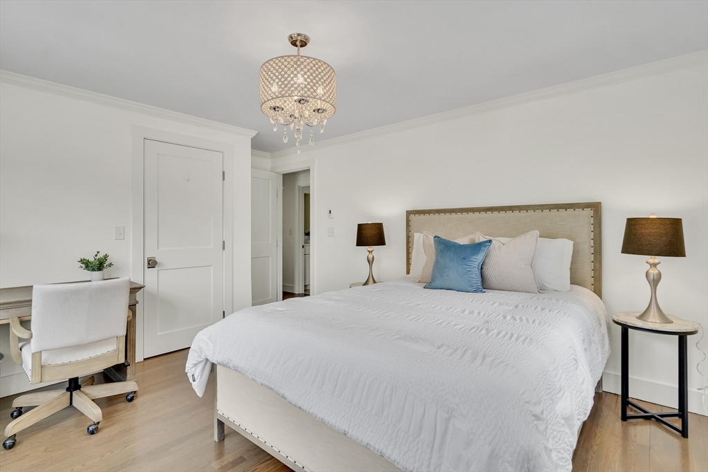 20 Lila Road Boston, MA 02130 - Photo 19 of 28 a bedroom with a bed and a chandelier