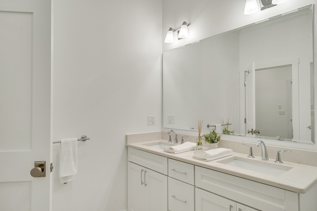 20 Lila Road Boston, MA 02130 - Photo 24 of 28 a bathroom with double sink and a mirror