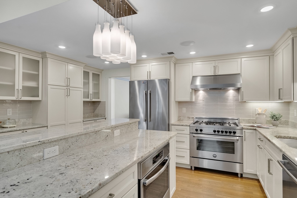 20 Lila Road Boston, MA 02130 - Photo 7 of 28 a kitchen with stainless steel appliances granite countertop a stove and a refrigerator
