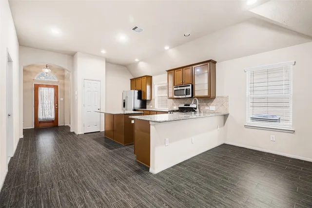 a view of a room with wooden floor and windows
