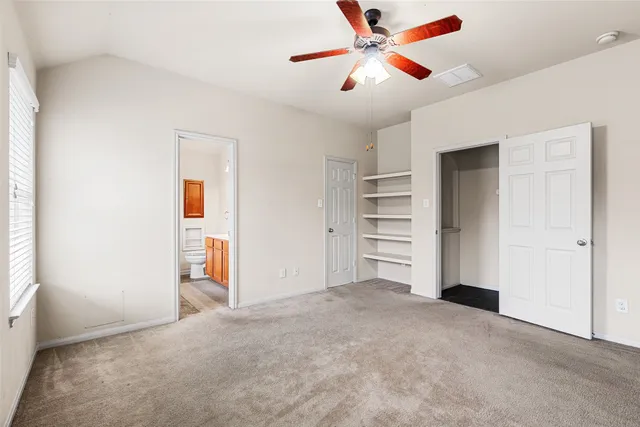 a spacious bathroom with a granite countertop sink mirror and a toilet