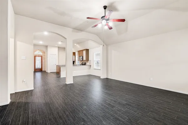 a view of kitchen and hall with wooden floor