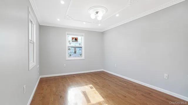a view of a room with wooden floor and window