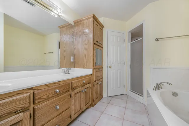a white bath tub sitting next to a shower