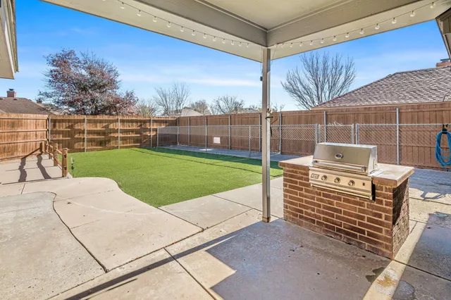 a view of a backyard with sitting area