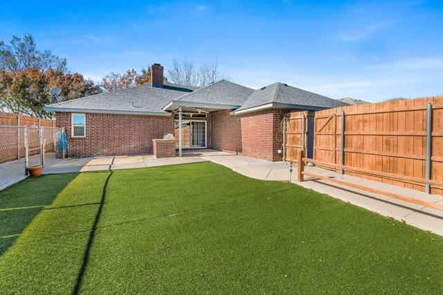 a house view with a sitting space and garden