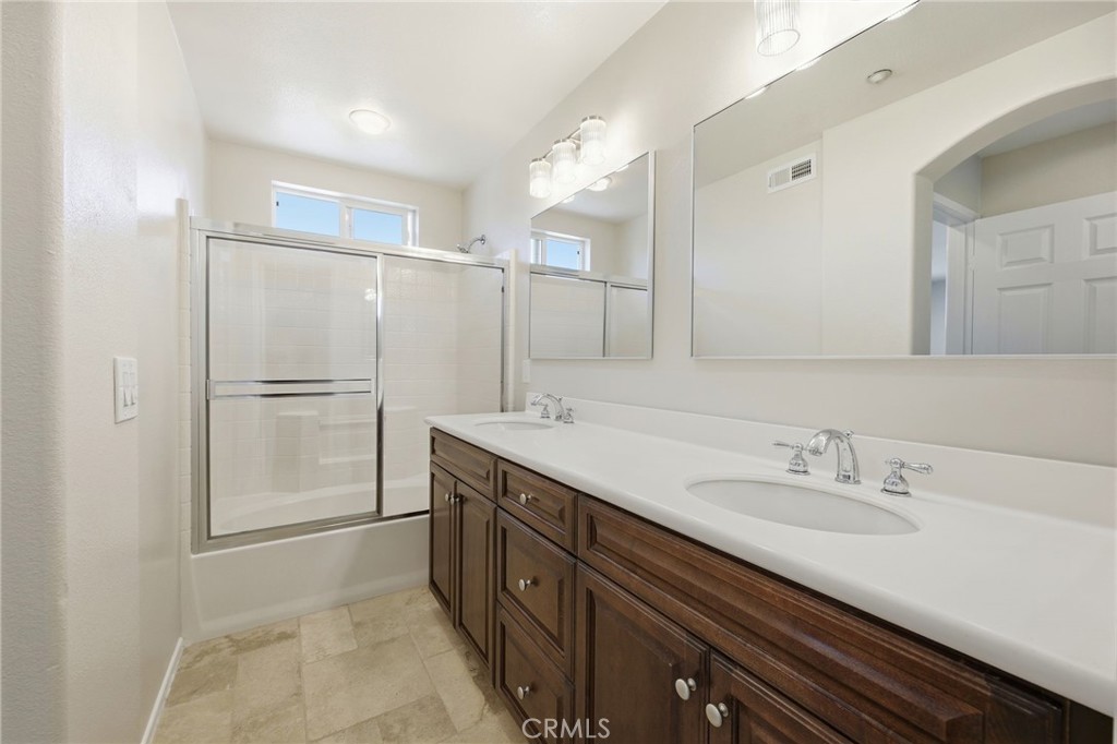 3603 Jetty Carlsbad, CA 92010 - Photo 26 of 43 a bathroom with a double vanity sink mirror and shower