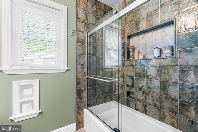 a bathroom with a sink a mirror and a shower